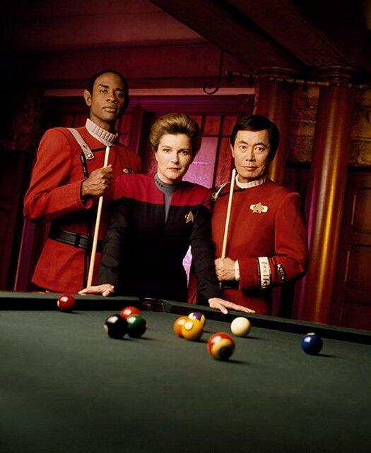 Tuvok, Kathryn and Sulu standing next to a pool table in Sandrine's