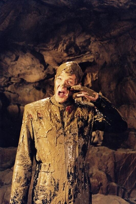 Tom covered in mud.