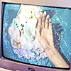 cathode ray tube television with an aquatic graphic on it, a hand is touching the screen
