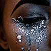 a closed eye with glittery eye makeup