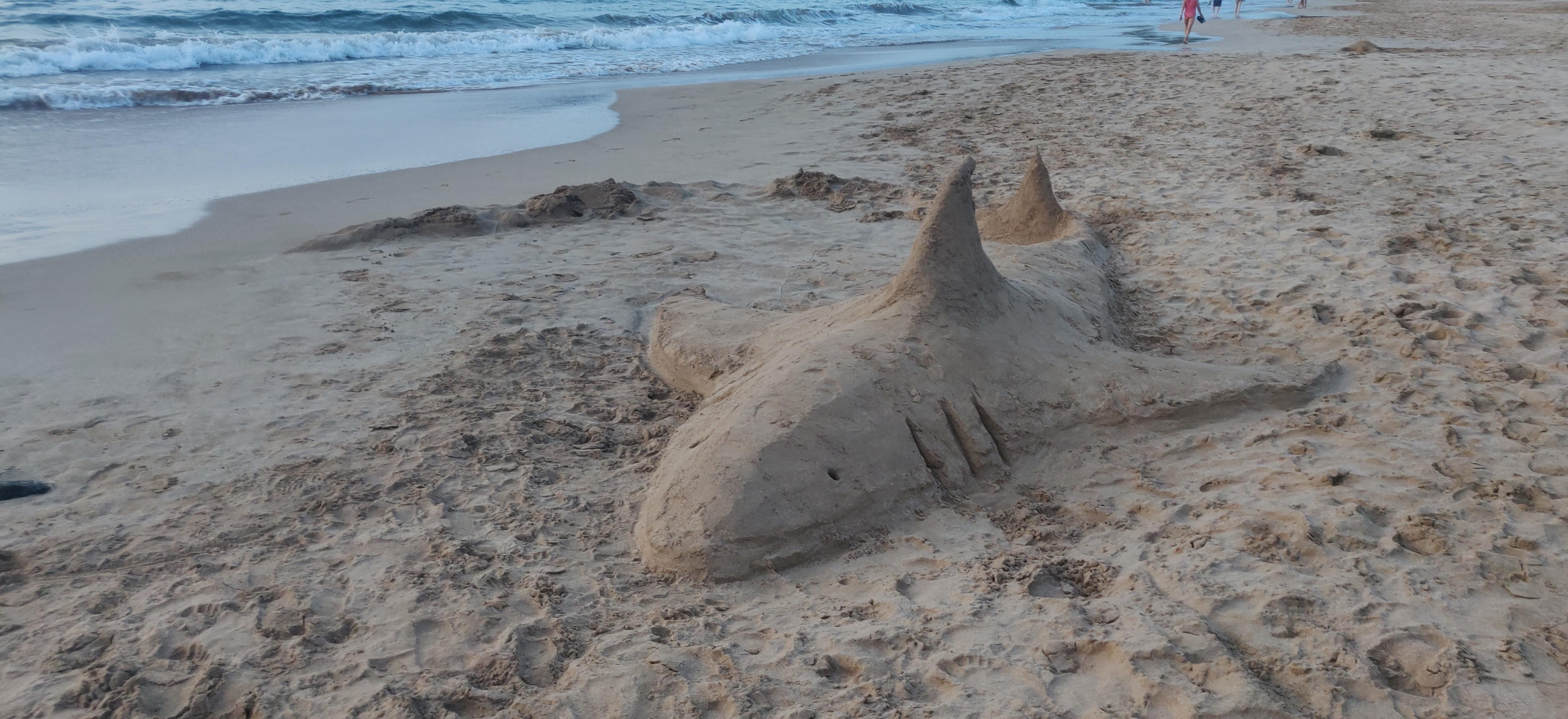 Youtube thumbnail of a shark sandcastle