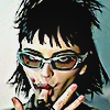 aesthetic photo of a model wearing cool glasses looking threatening and sticking her finger in her mouth