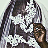 aesthetic photo of a model wearing a whtie floral veil