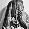 aesthetic photo of a model wearing a white floral veil and holding a cigarette