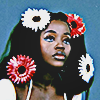 aesthetic photo of a model with big poofy flowers in her hair