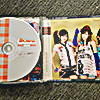an open buono kiss kiss kiss jewel case with a disc and booklet inside