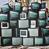 CRT televisions outside stacked upon each other