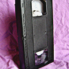 a black VHS tape stood upright