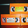 three orange nickelodeon VHS tapes