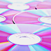 a stack of colorful iridescent CDs