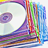 a stack of colorful CDs in jewel cases