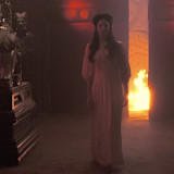drusilla with flames in the background