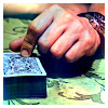 hand pointing to deck poker cards on table
