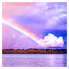 rainbow over sea with clouds