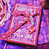 the artms lightstick on a matching pink sparkling jeweled book