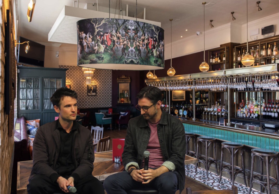 Dream and Hob sit in the New Inn holding microphones in their laps