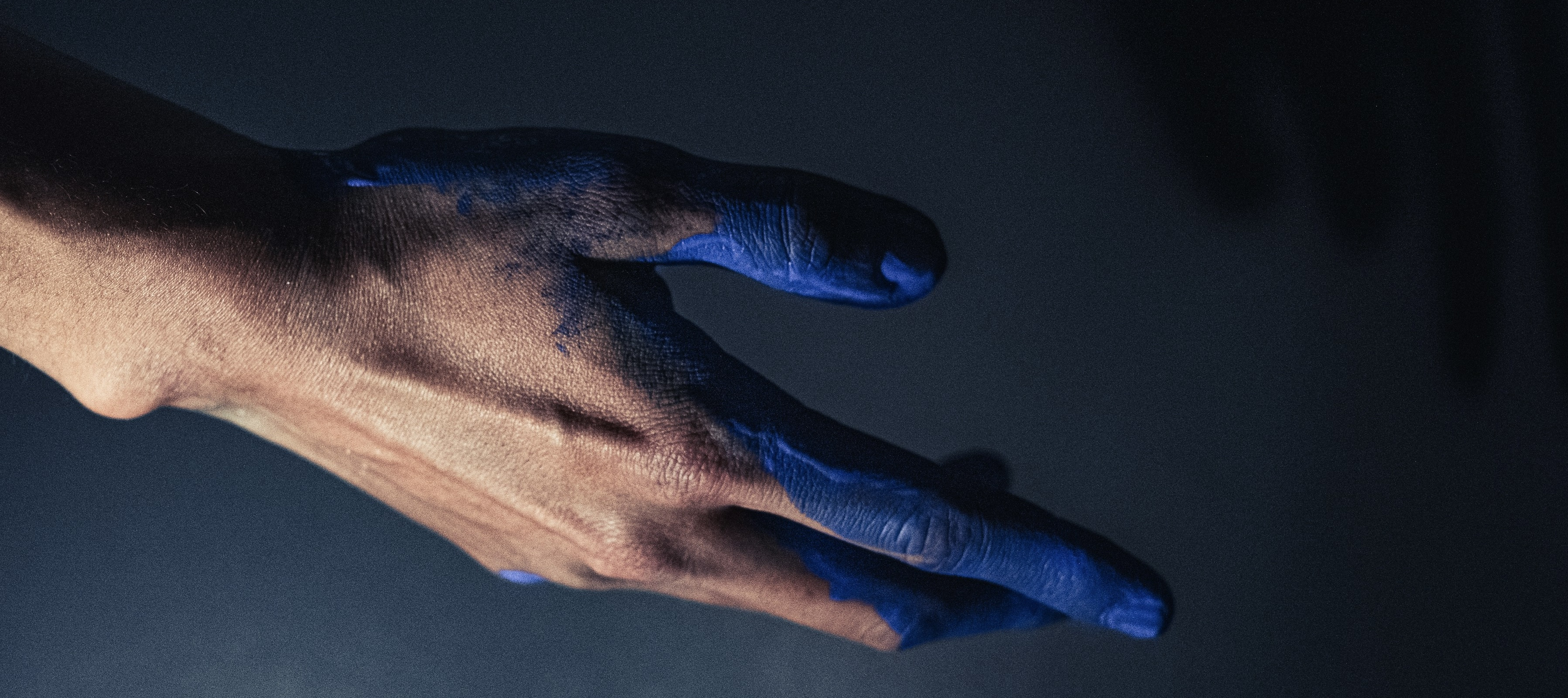 Banner. Hand covered in blue paint.