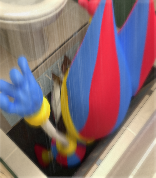 Pomni falling through a trapdoor in the floor