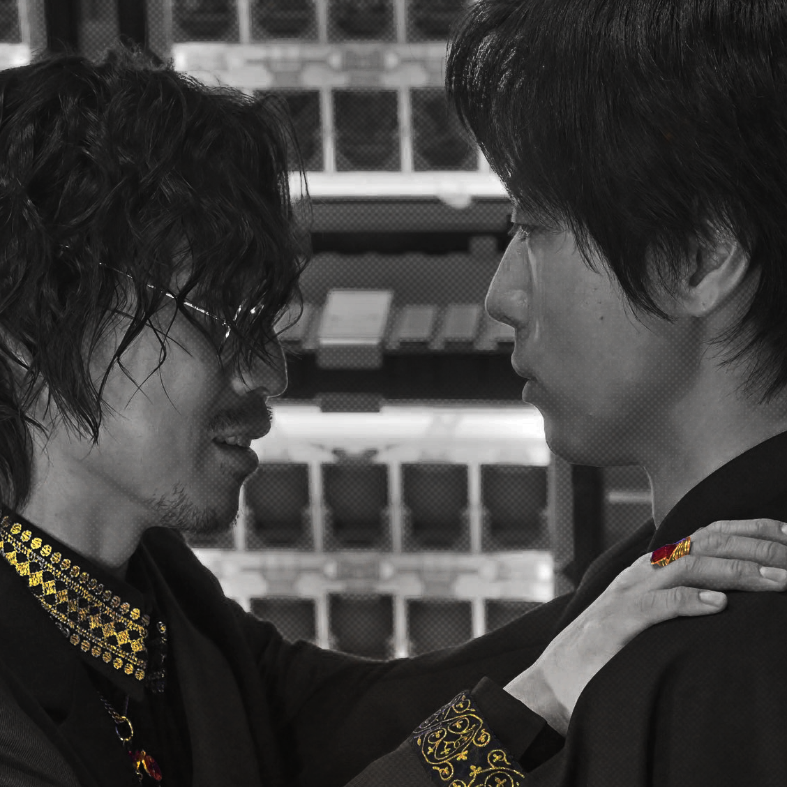 Geryon placing his hand on Minato's shoulder and neck. This version is cropped into a square, centering on the two.