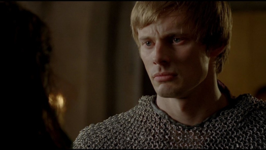 a shot of Arthur looking conflicted and angry as he stares at Gwen after finding her and Lancelot kissing.