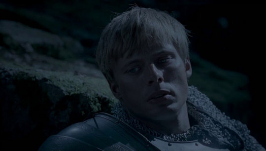 Arthur in the last episode looking off to the side sadly as he watches Morgana be killed by Merlin