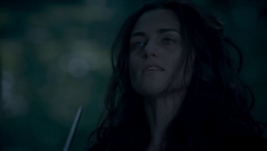 a dark picture of a defiant Morgana with excalibur pointed out her right before Merlin kills her