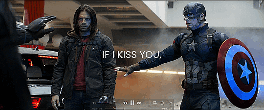 a gif of Steve protectively holding his hand out in front of Bucky after the car chase in Germany and there are guns pointed at them and the text on the gif reads in all capitals IF I KISS YOU.