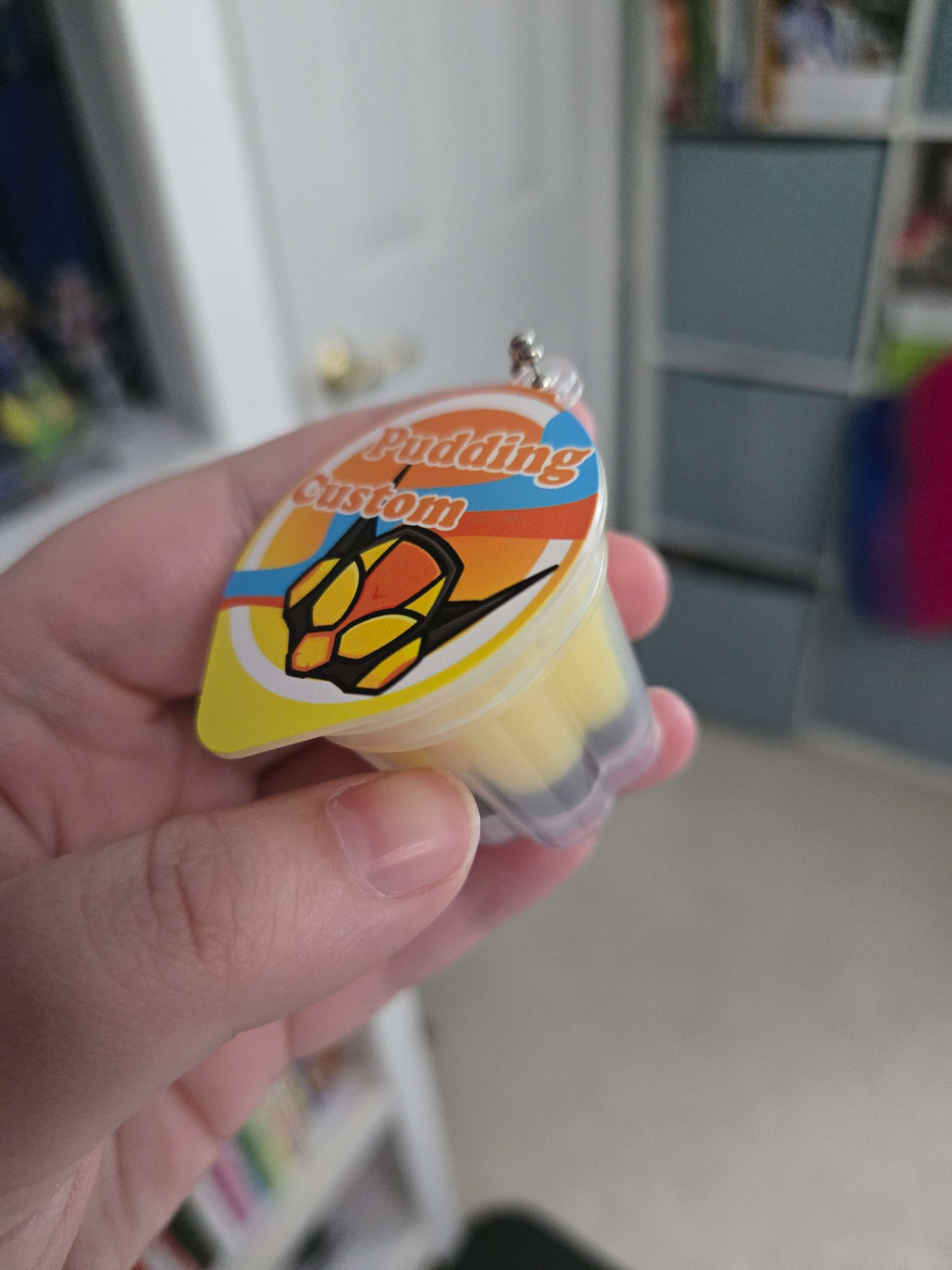 My hand holding the pudding custom charm.