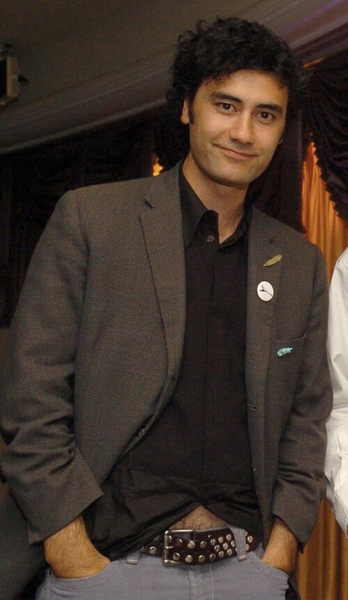 Young Taika wearing a black shirt and blazer