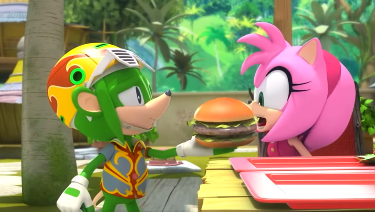 Screencap from Sonic Boom. Swifty, a green anthro rodent shrew, holding out a burger as Amy, a pink anthro hedgehog with short quills mimicking a bob haircut, takes a bite from it.