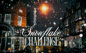 Snowflake Challenge: A warmly light quaint street of shops at night with heavy snow falling.