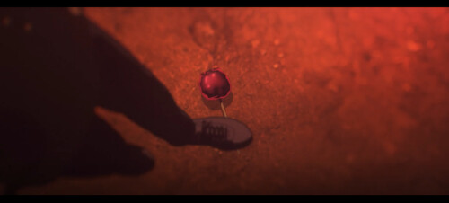 screenshot of a person about to step over a caramellized treat dropped on the ground