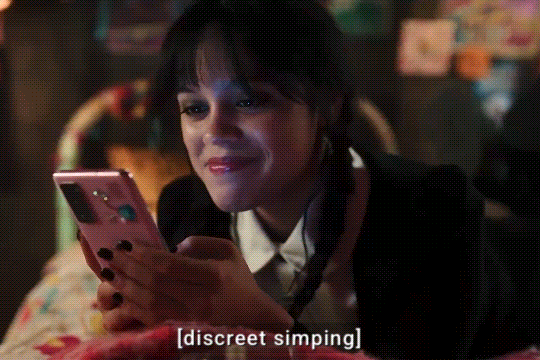 Wednesday laying on Enid’s bed and watching Enid’s dance on a phone, when Agnes confronts her and asks “Why are you scenting Enid’s side of the room?”.