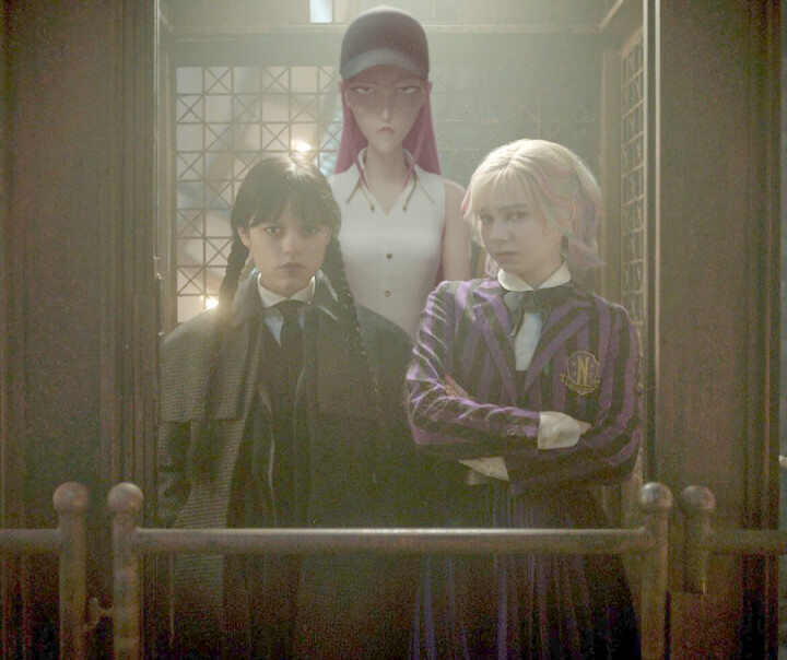 Wednesday and Enid on an elevator with Mira from KPop Demon Hunters.