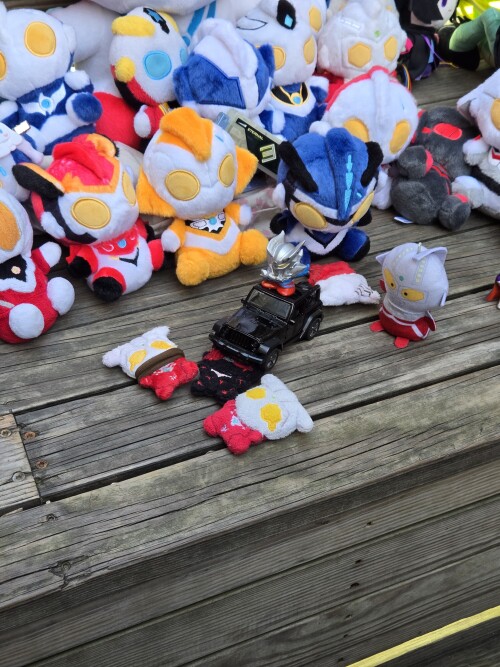 Ultraman Leo plushies made to look run over by a toy jeep.