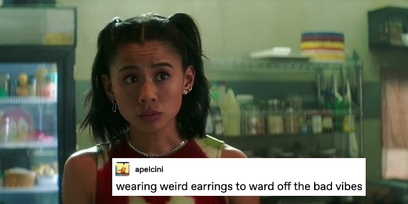 Screenshot of Nancy Drew 403, The Danger of the Hopeful Sigil. George is standing in the Claw kitchen, looking at someone with her eyebrows raised, the front of her hair up in two ponytails on the sides of her head so that several different silver earrings are visible on each earlobe, none of them matching. A text post over top from tumblr user apelcini reads: wearing weird earring to ward off the bad vibes