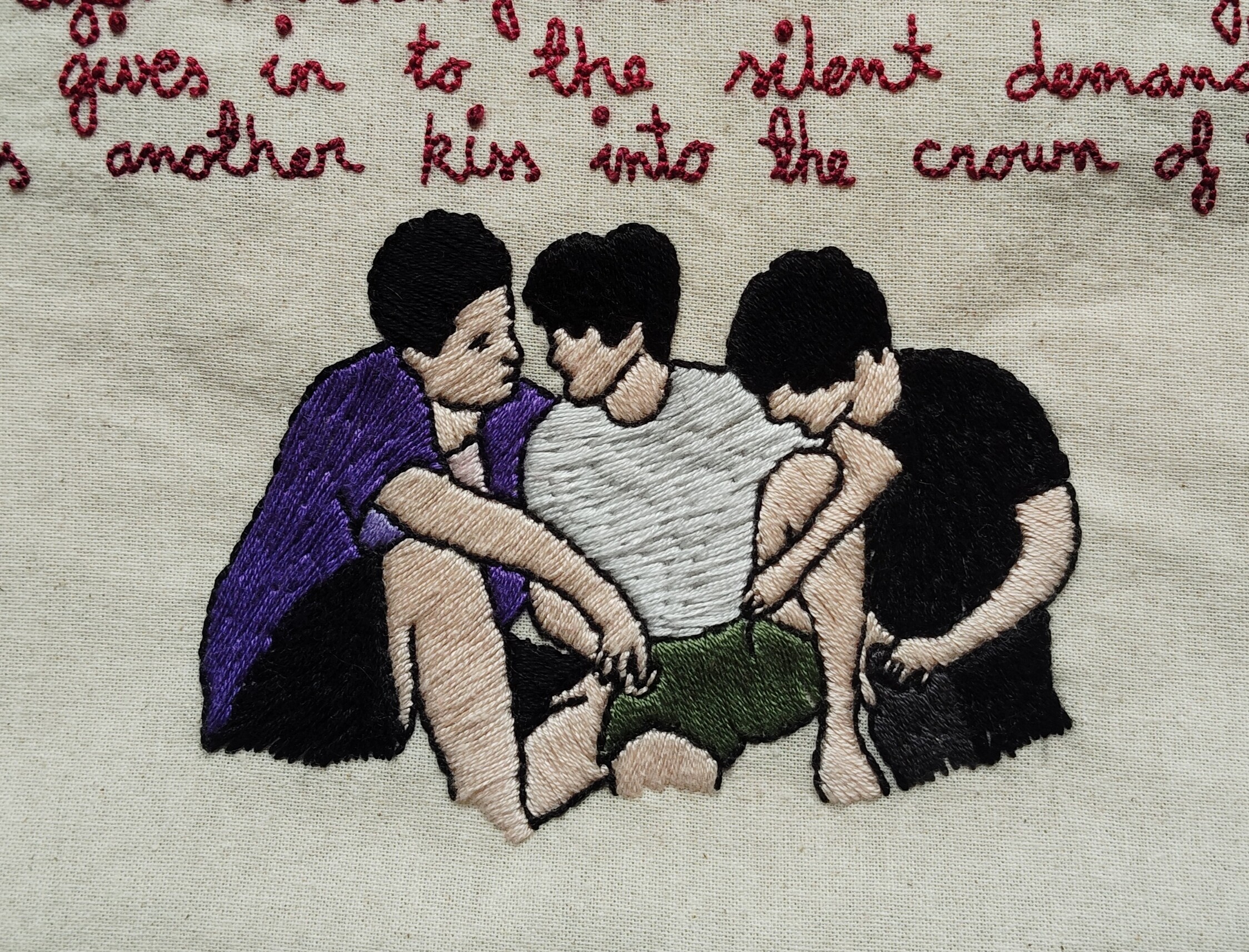 Embroidered tote bag. Close up of the embroidred image of the iron triangle.