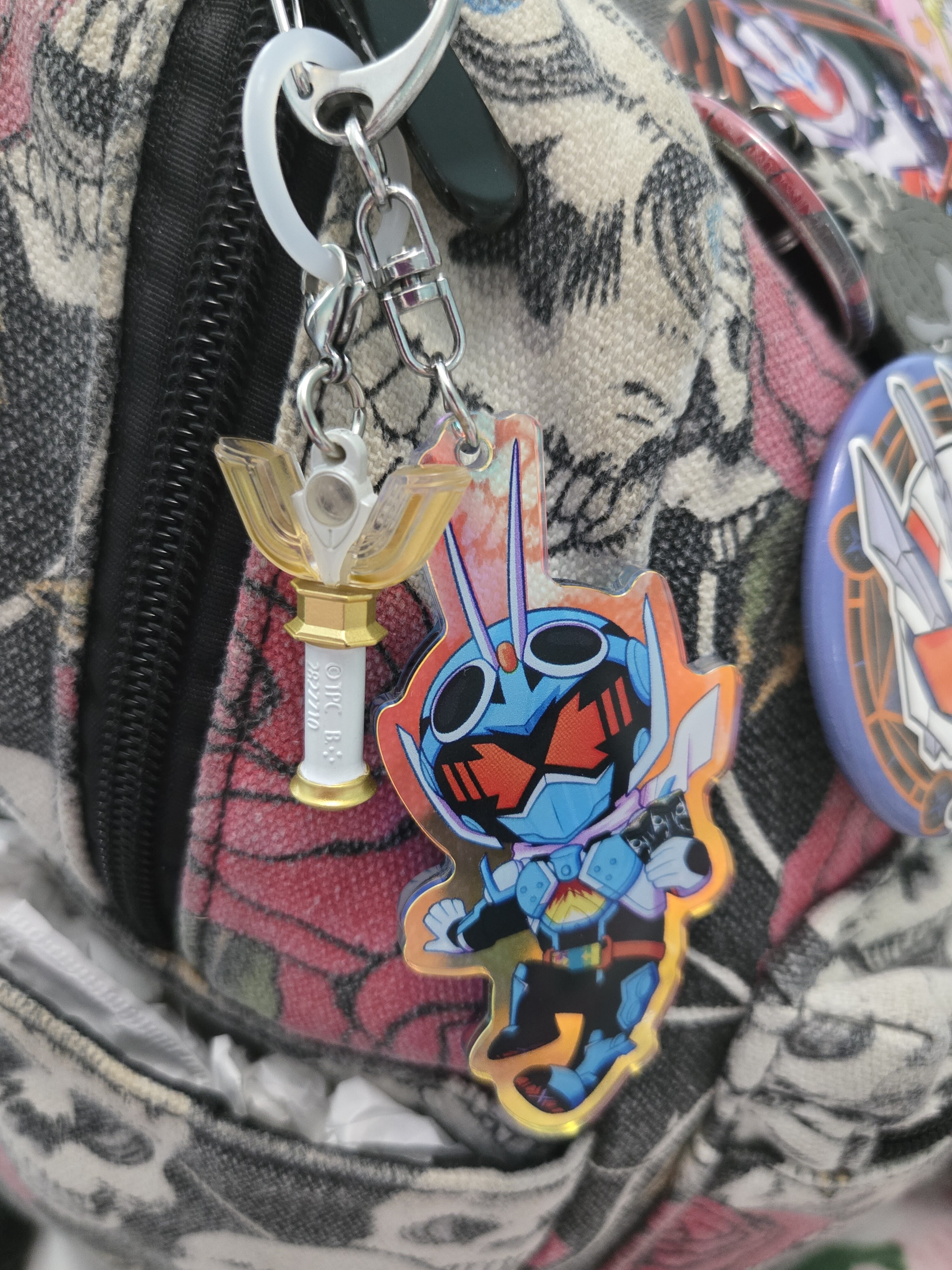A Sparklence Keychain next to a Gotchard keychain.