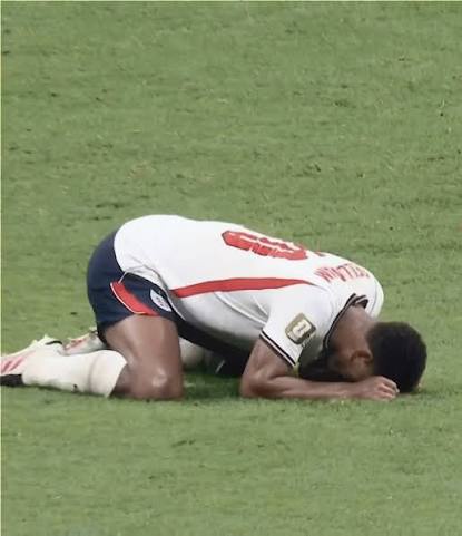 Jude Bellingham kneeling on the pitch
